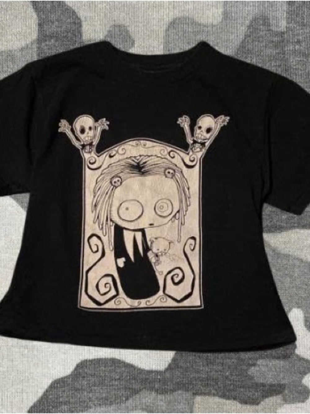 Beige creepy cartoon print with skulls. Soft cotton look and bold front graphic.